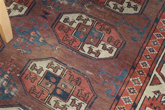 A Bokhara burgundy ground carpet 287 x 172cm